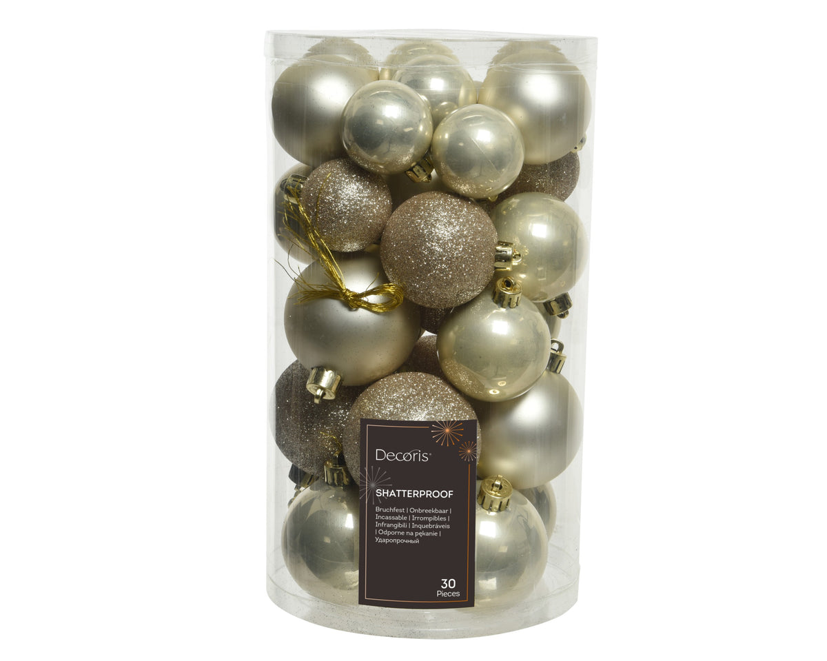 A clear cylindrical plastic container filled with 30 decorative Christmas ornaments in metallic silver, champagne gold, and glittery bronze finishes. A dark brown label on the front reads 'Decoris' and 'SHATTERPROOF'.