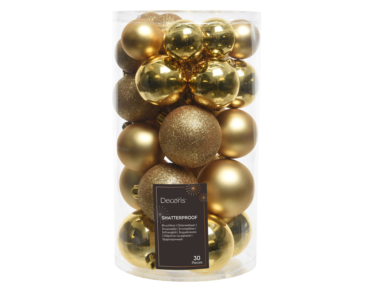A clear cylindrical plastic container filled with 30 gold shatterproof Christmas ornaments of various sizes and finishes, including metallic, glitter, and matte textures. A black label on the front reads 'Decoris SHATTERPROOF' and '30 ORNAMENTS'.