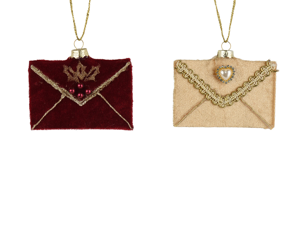 Two small envelope-shaped hanging ornaments on gold chains, shown side by side against a white background. The left ornament is deep burgundy velvet with gold trim and a small gold crown motif with red beads.