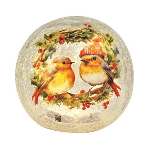 A round glass snow globe featuring a festive Christmas wreath with red berries and two robin birds, one wearing a small orange hat, set against a white background.