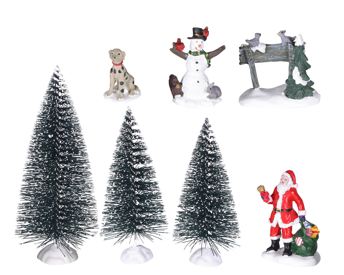 A set of six Christmas-themed decorative items on a plain white background, including three small snow-covered artificial trees, a Santa Claus figurine, a snowman, a dog, a mailbox with birds, and a green wreath.