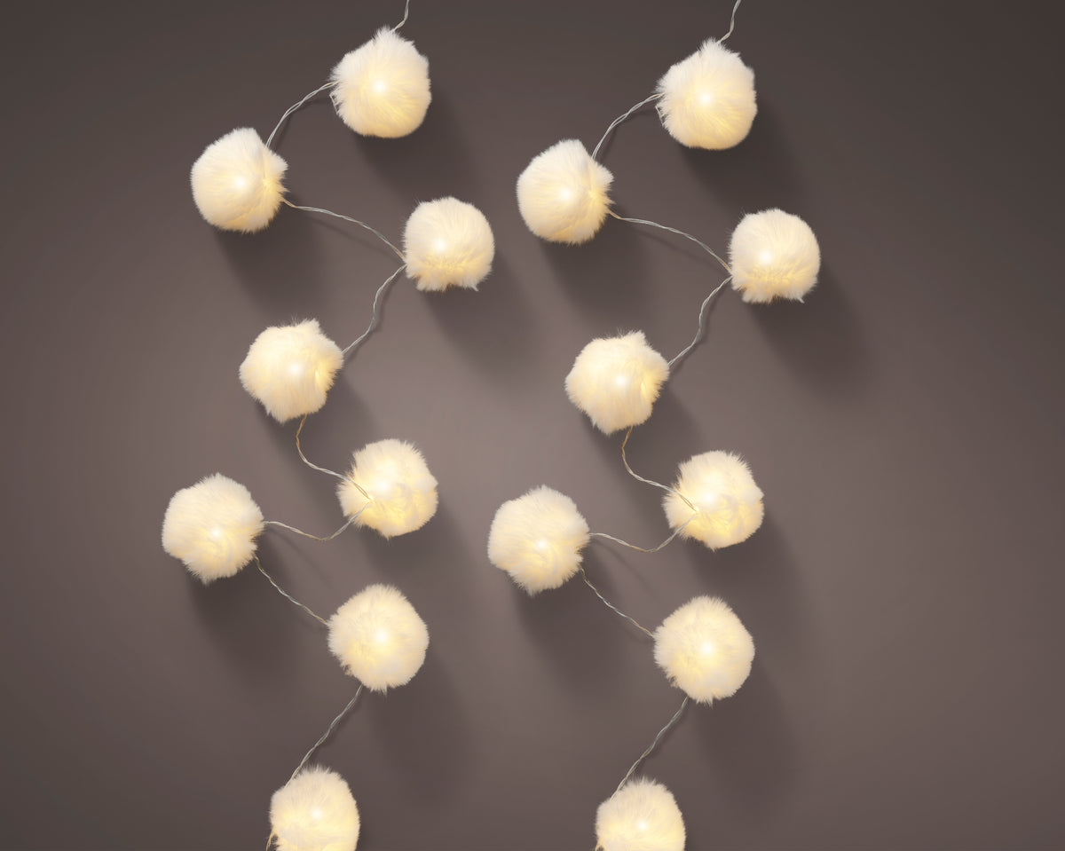 Feather white string lights on black background
